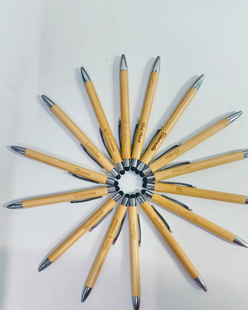 Laser-engraved bamboo pens arranged in a circle